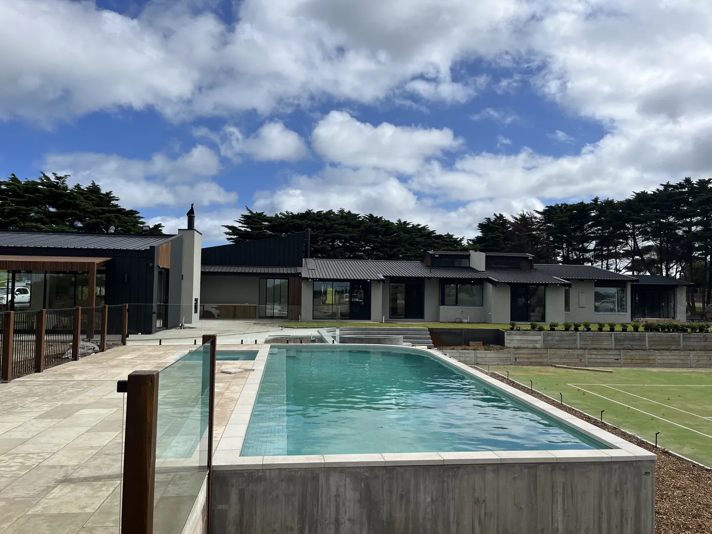 Modern house with swimming pool and garden view.