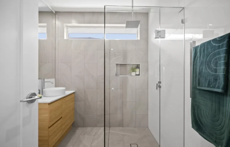 Modern bathroom with glass shower and wood vanity