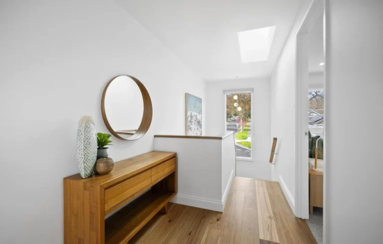 Modern hallway with wooden console and round mirror