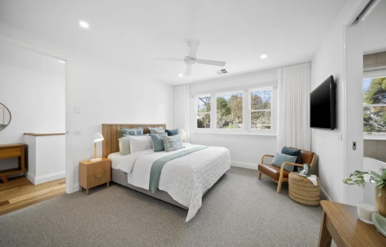 Modern bedroom with large bed and windows